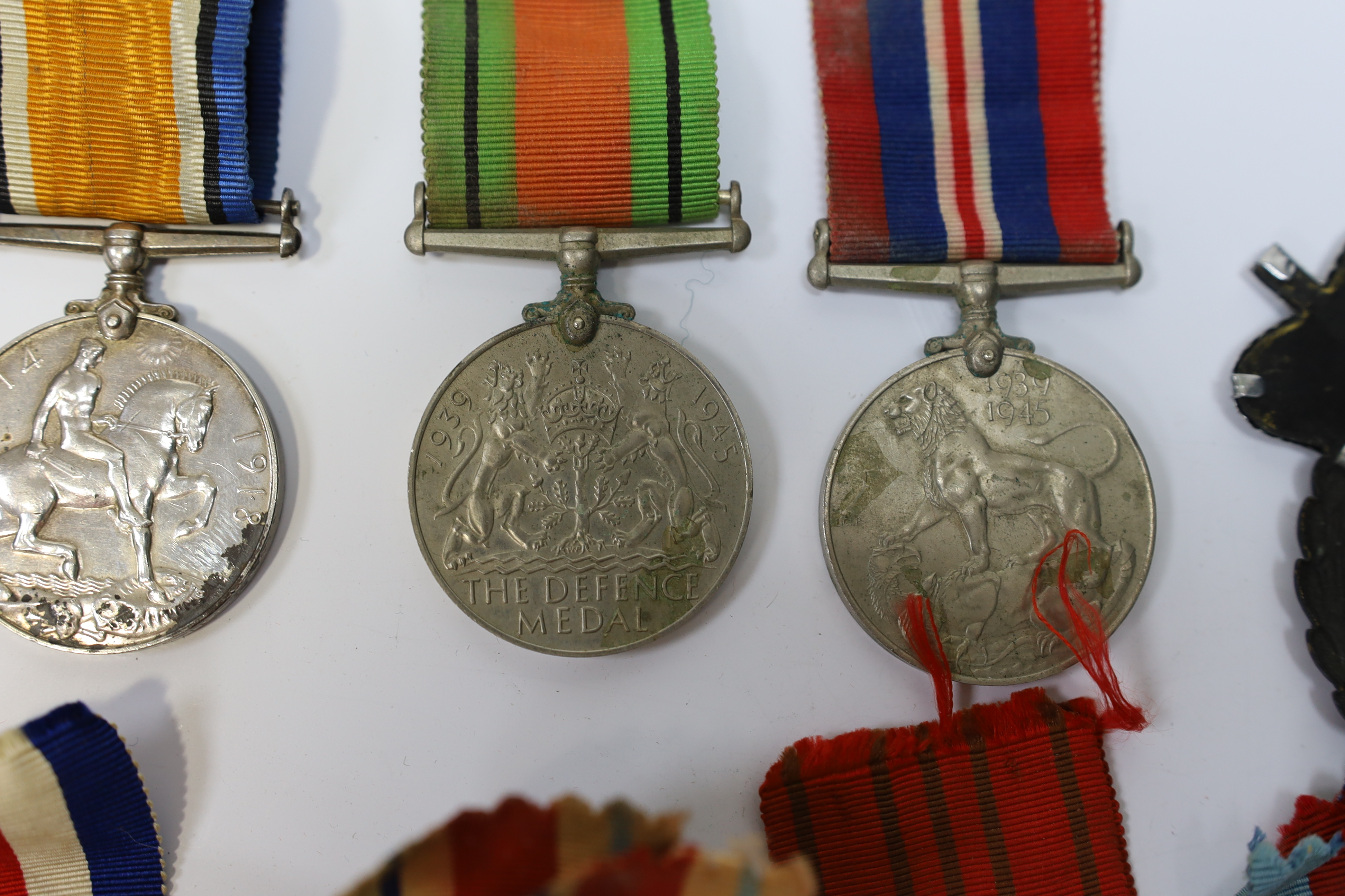 Seven medals including; a First World War British War Medal awarded to PTE. H. Lee DURH. L.I., A 1939-1945 medal, The Defence Medal, the Africa Star, the France and Germany Star, the 1939-1945 Star, plus a GPO cap badge.